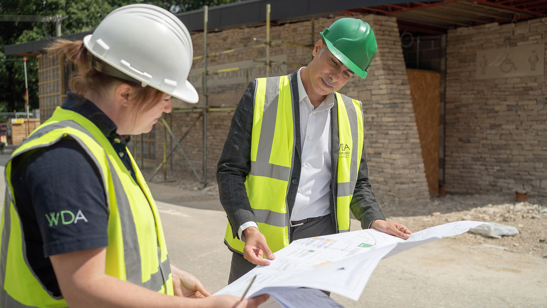 Architects on a construction site looking at drawings