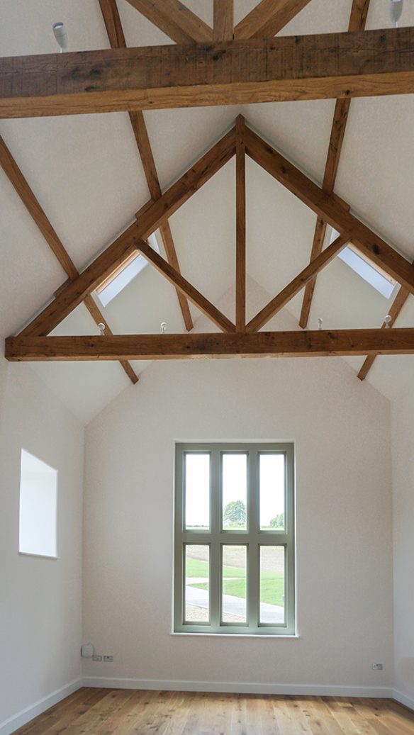 interior of large double height room with vaulted ceilings and exposed wooden beams