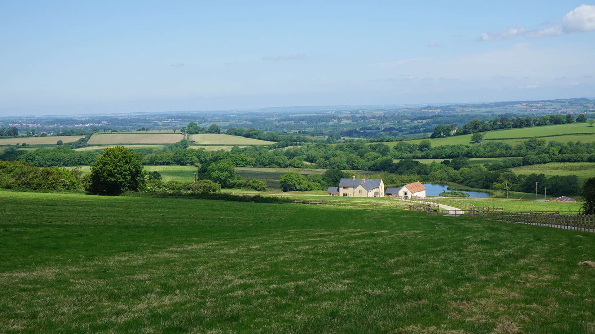 distant view of finished farmhouse from main road with beautiful scenic views