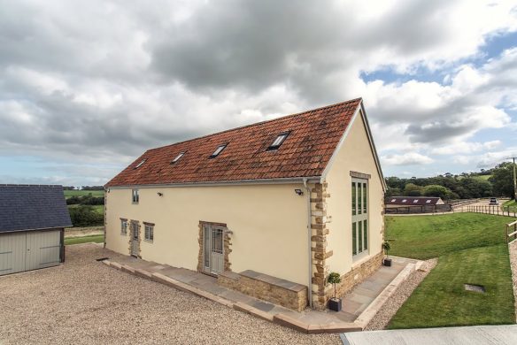 entrance view to large annex with garage to the left and driveway behind