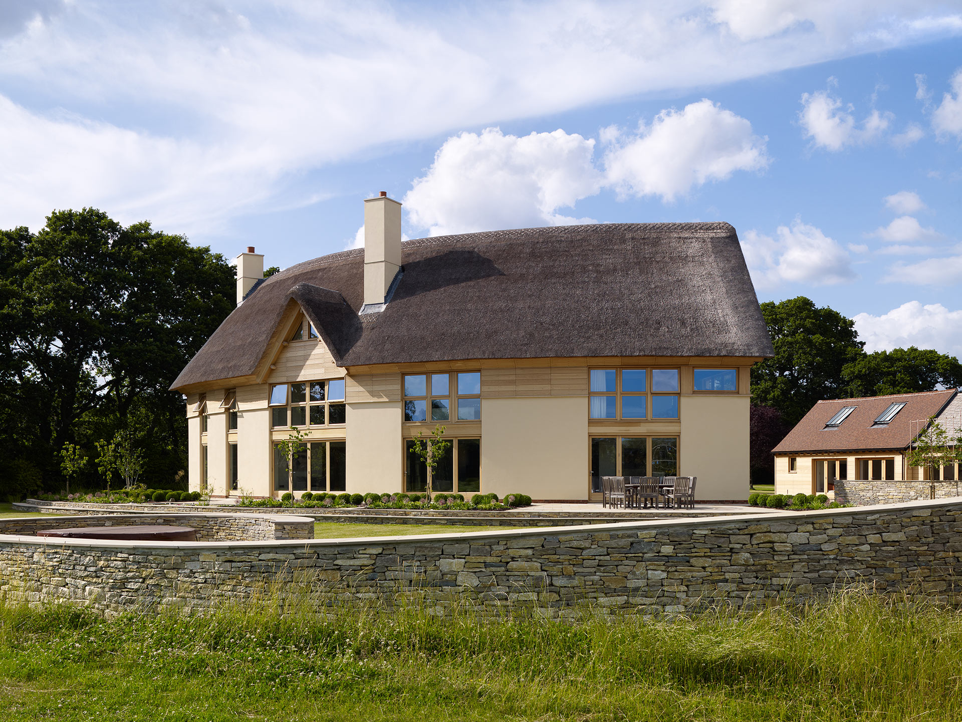 rear view of unique curved house with thatched roof