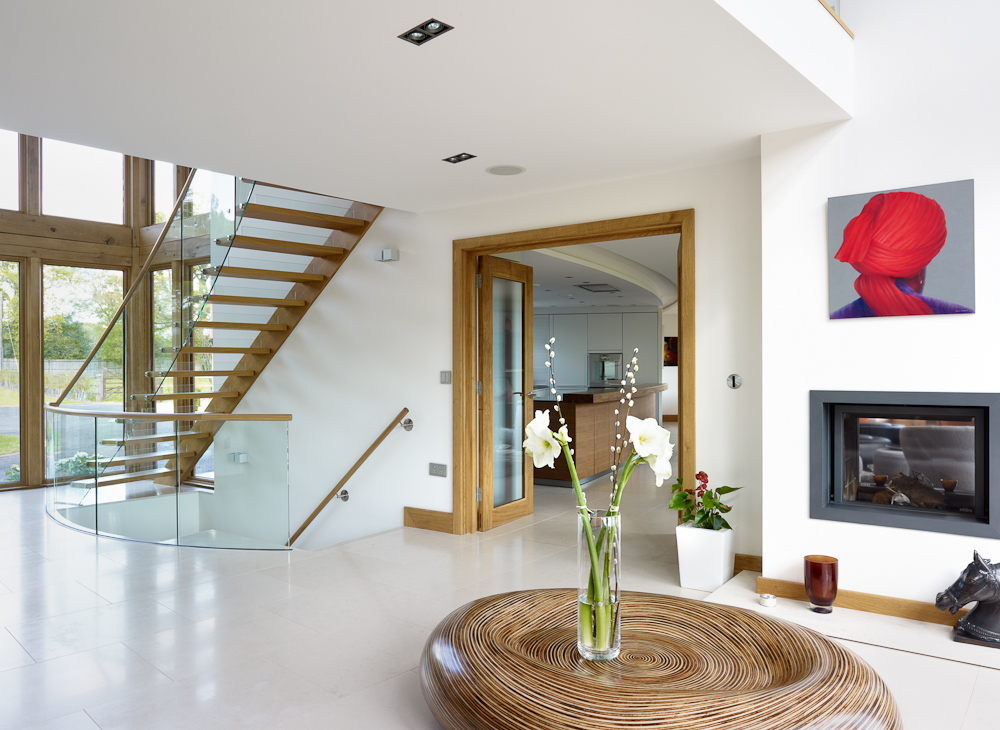bright and spacious entrance area with feature staircase and kitchen