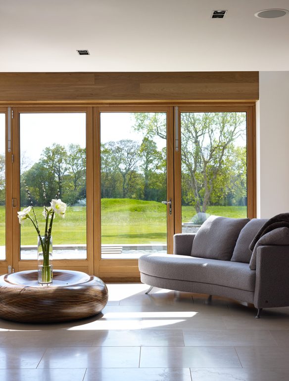 seating area in neutral tones with patio doors leading to garden