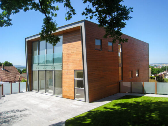 rear view of contemporary house with timber cladding and sea views