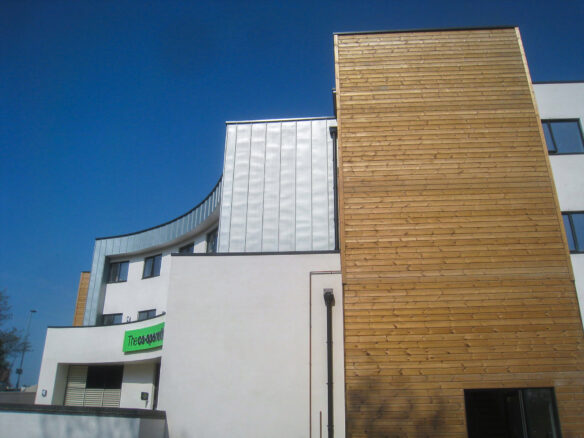 side view of retail shop with flats above with timber cladding and zinc cladding