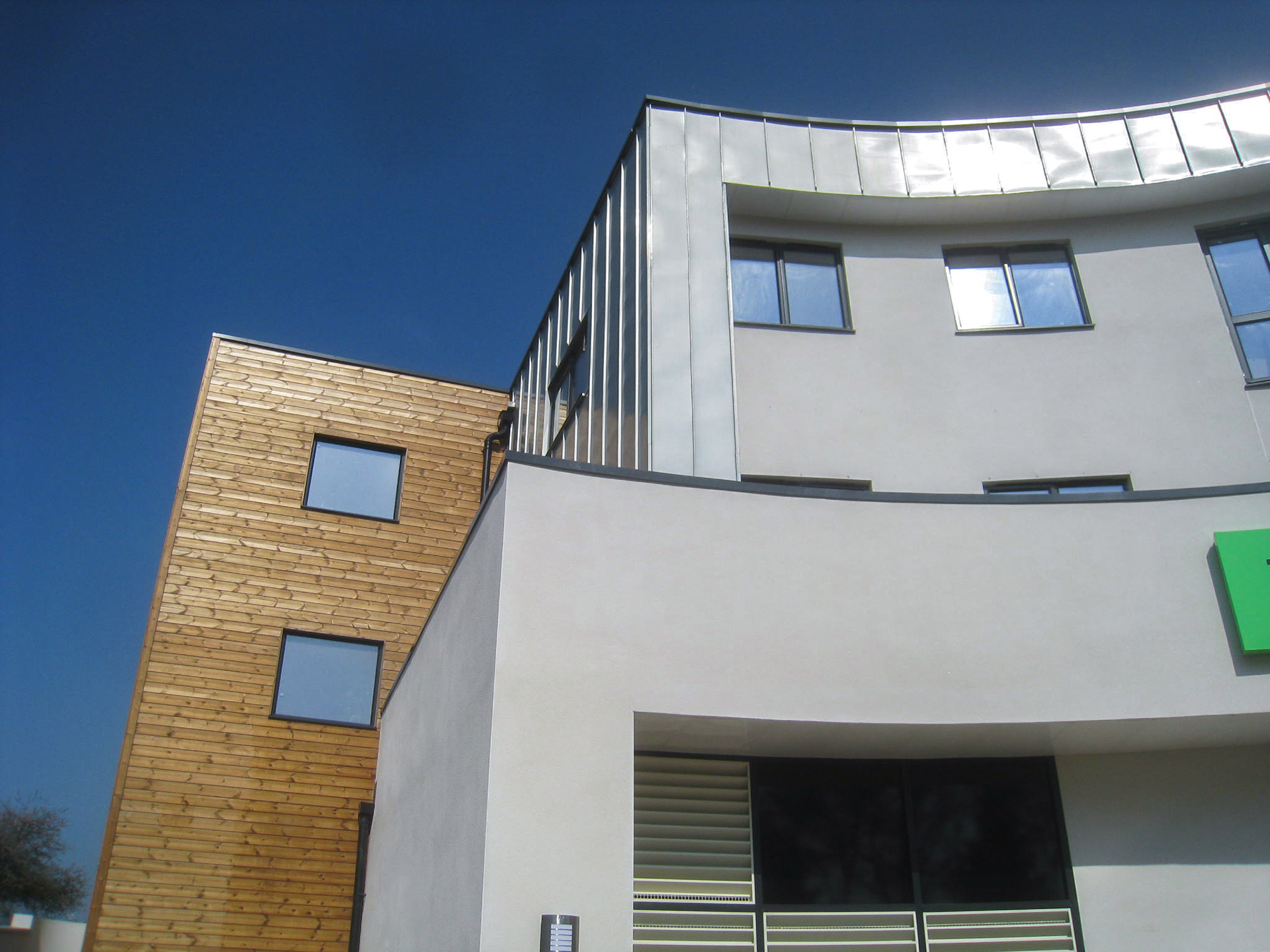 front detailed view of retail shop with flats above with timber cladding and zinc cladding