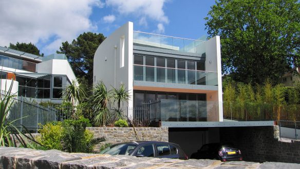 street view of two modern white houses with curved wall and balconies