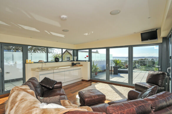 entertainment room with double aspect windows and sea views