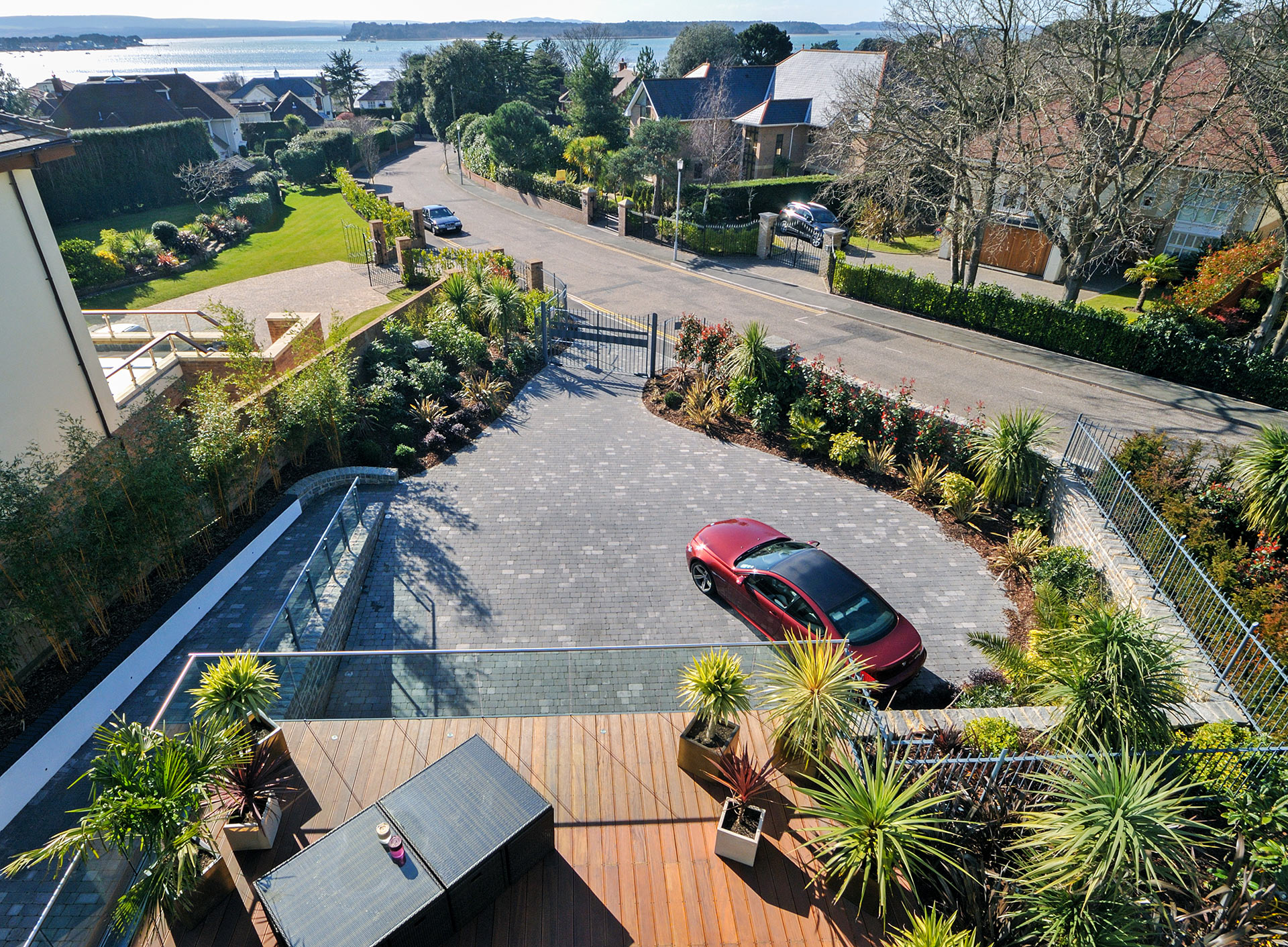 view of driveway from balcony with sea views