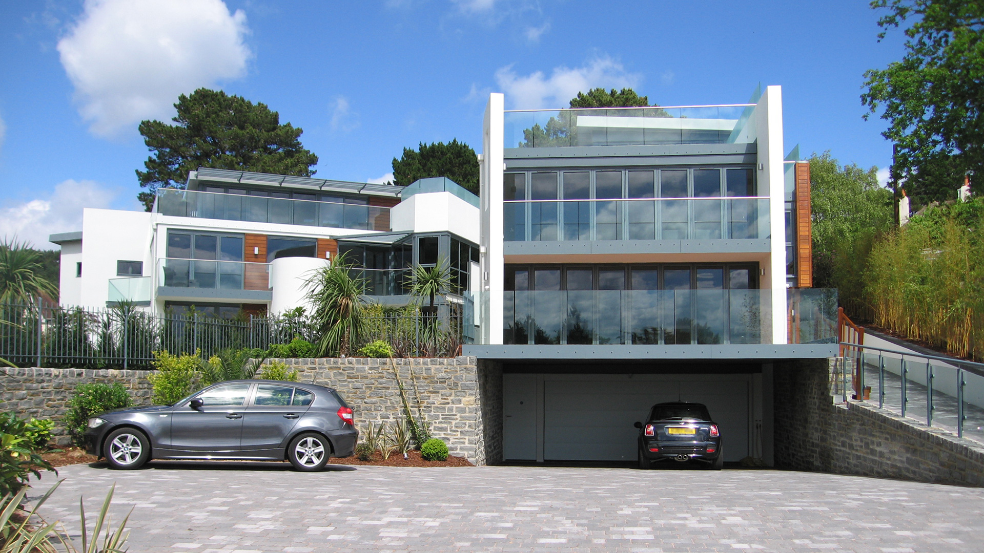 approach view of two contemporary houses with large balconies on each floor