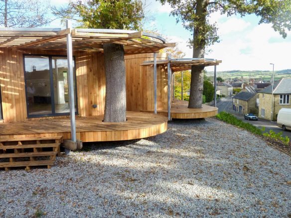 elevated garden view of timber house with decking and road