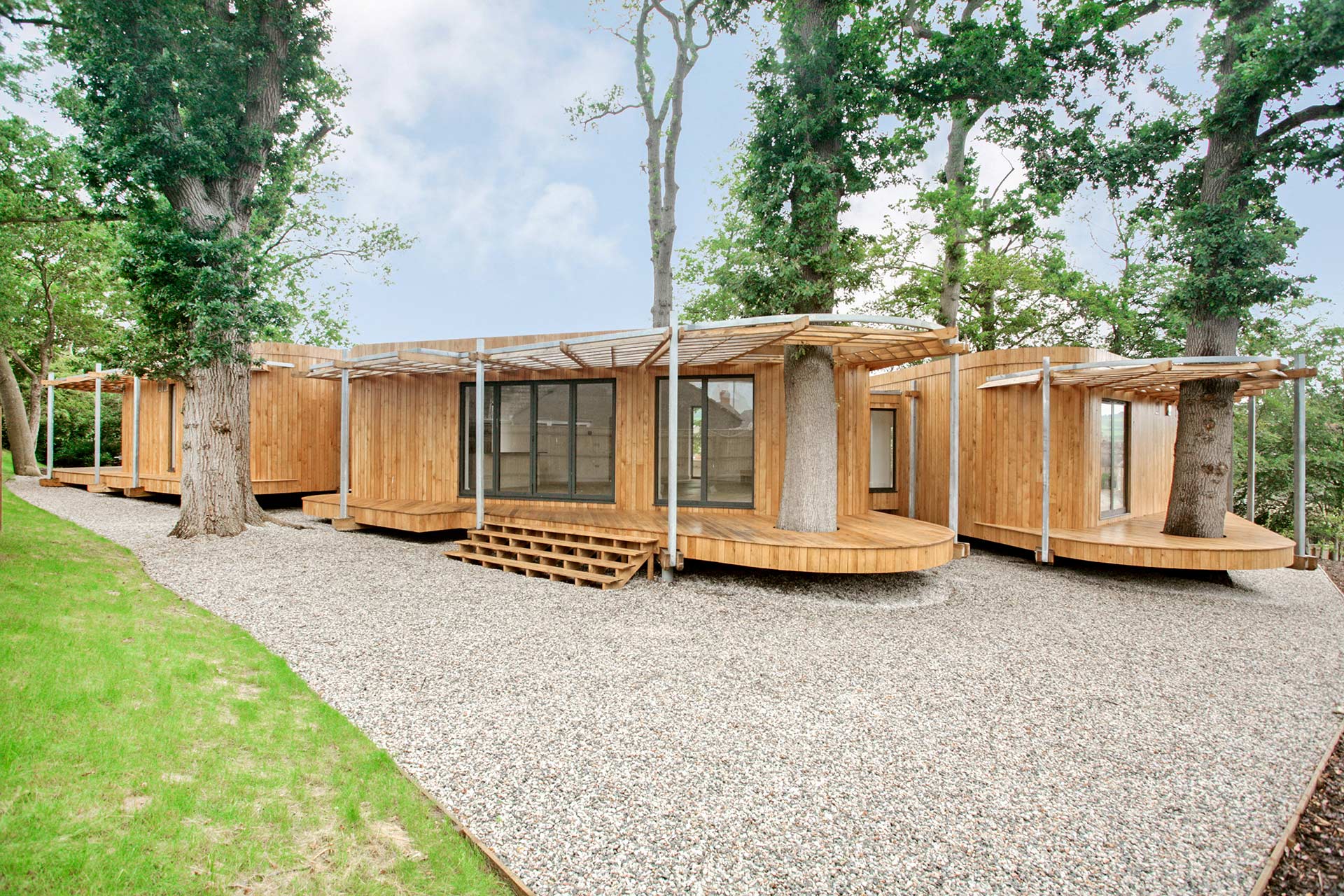 timber cladded house in pod style surrounded by trees