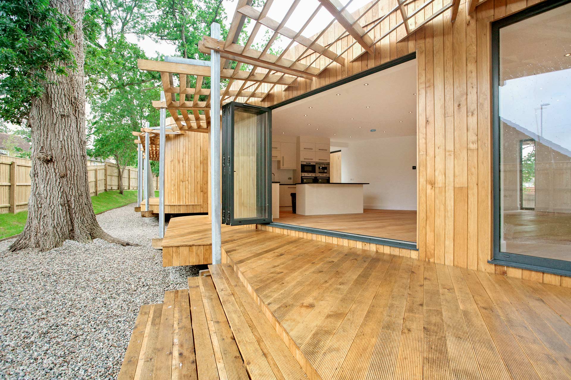 view looking into kitchen living area from decking with timber cladding