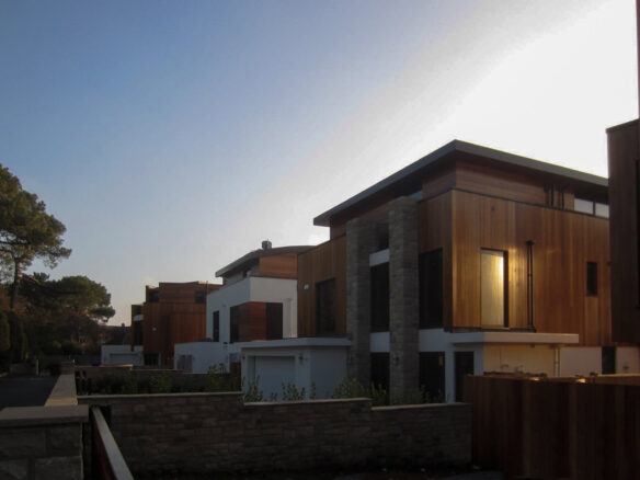 rear view of houses with timber cladding at dusk