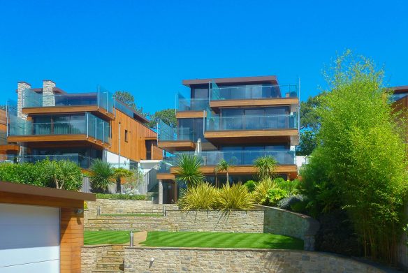 garden view of house with glass balconies