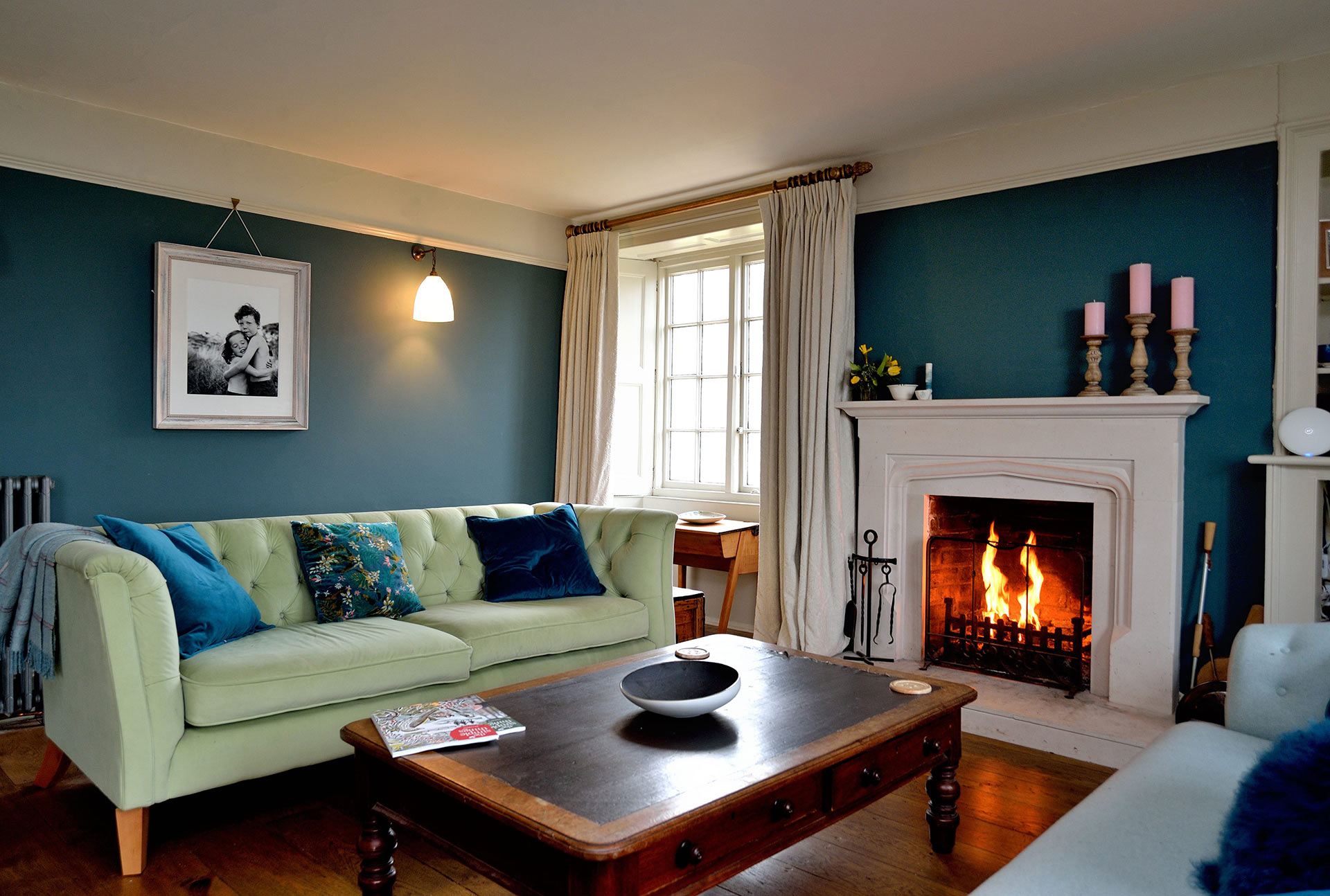 interior living room with blue walls and large open fireplace