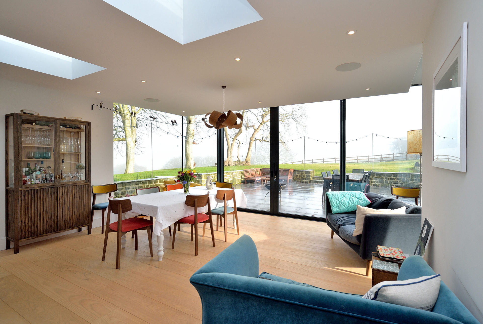 modern dining area extension looking outside to a terrace garden area