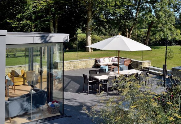 outdoor living dining area on patio with modern extension to house