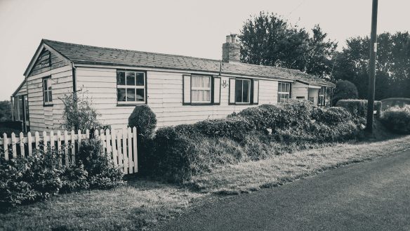 before photo of bungalow with wood cladding