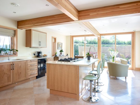 modern kitchen with kitchen island and large windows with view of garden