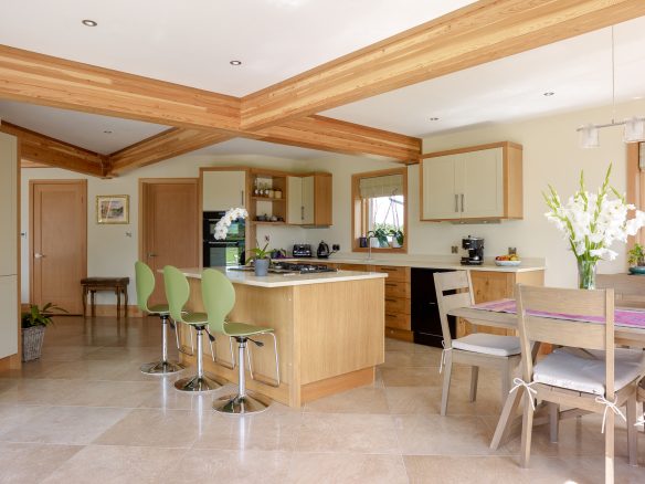 modern kitchen dining room with kitchen island and exposed ceiling beams