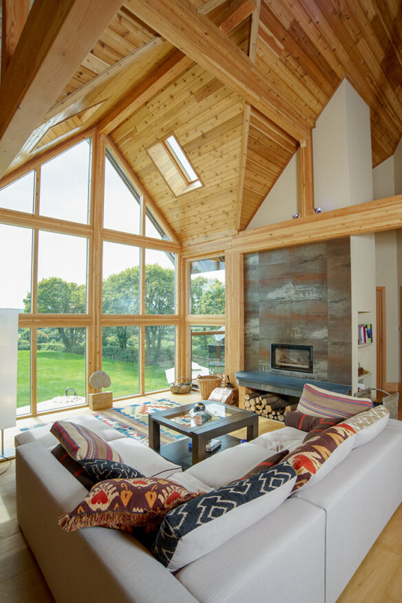 living area space on mezzanine level with double height vaulted ceilings and wood cladding