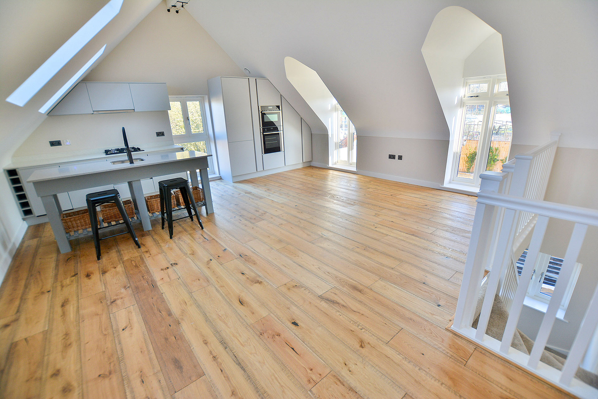 living and kitchen area with vaulted ceilings