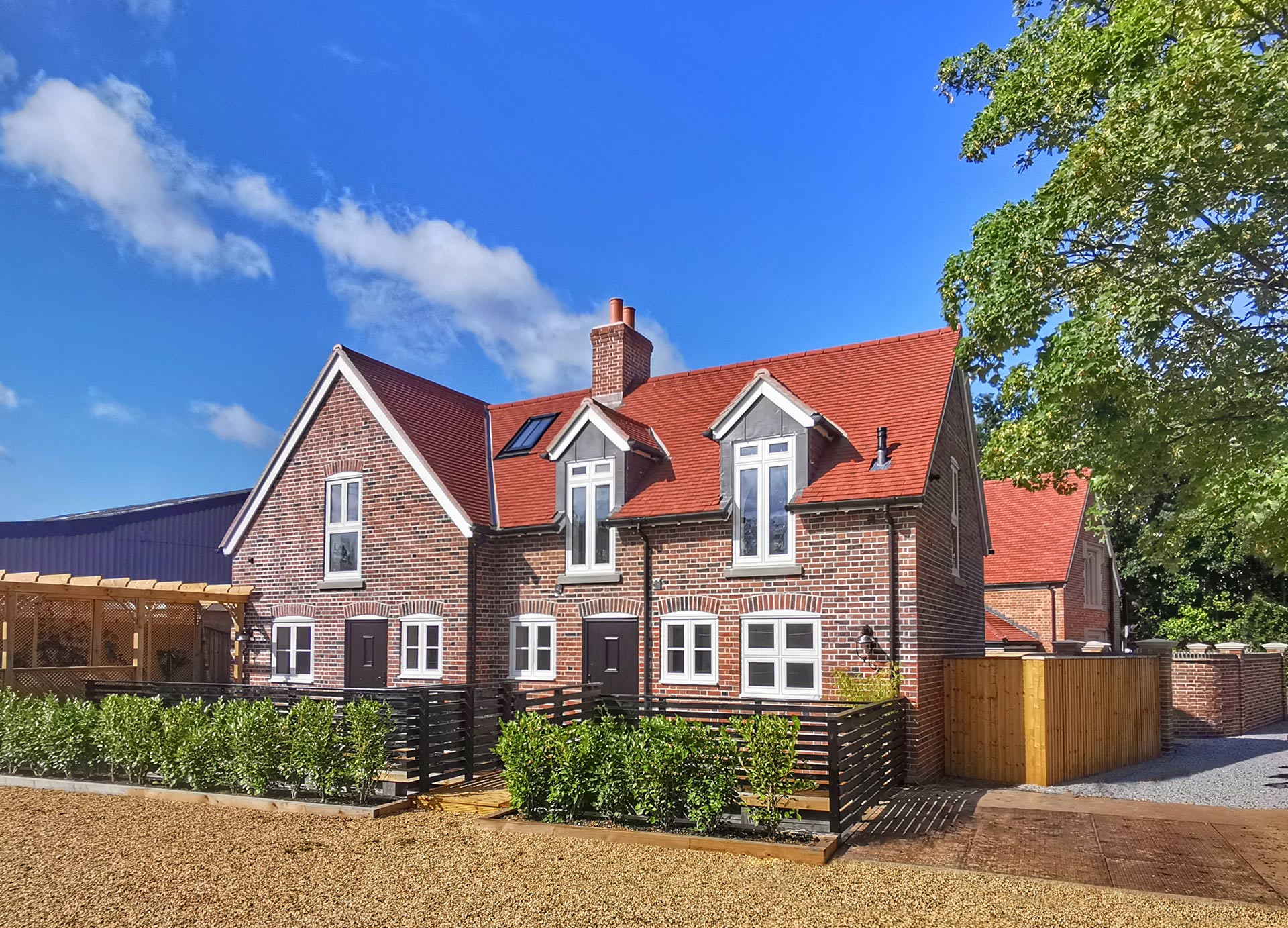 rear view of new red brick house with red tiled roof