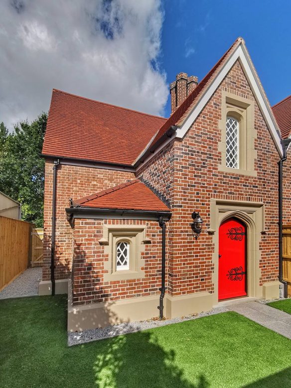 side view of red brick house with enclosed lawn garden