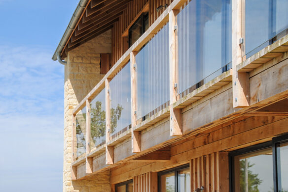 detail view of timber balcony with glass balustrade