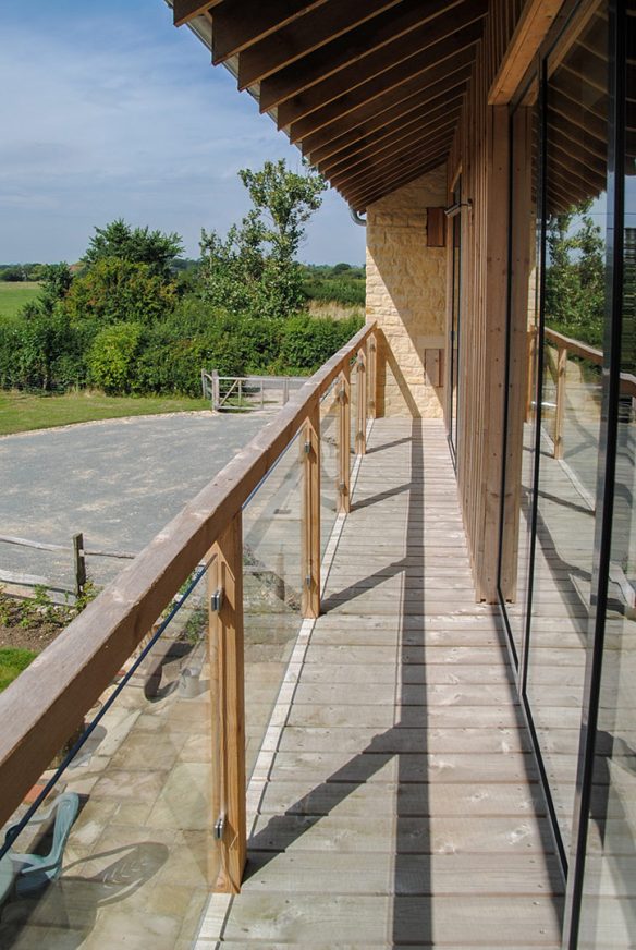 view along timber balcony with vaulted ceilings over