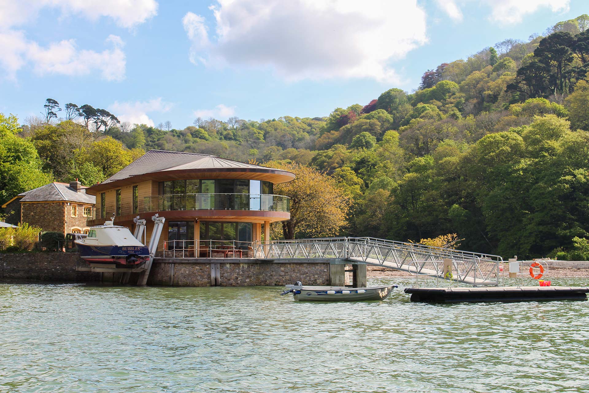 riverside house with pontoon at high tide from boat