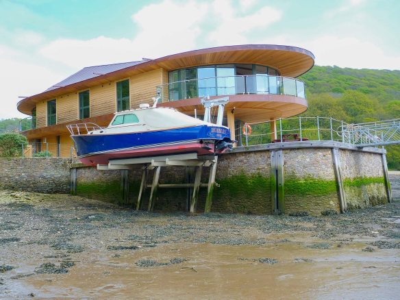 riverside house at low tide with stone plinth