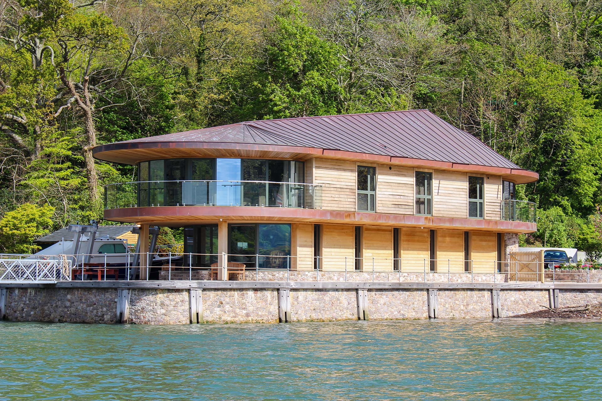 riverside house with pontoon at high tide from boat