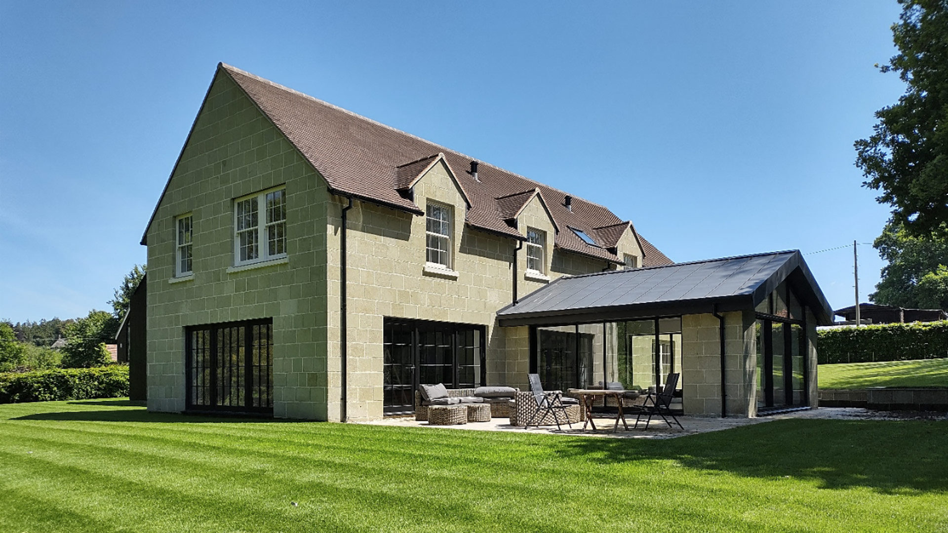 rear view of house with extension and patio area