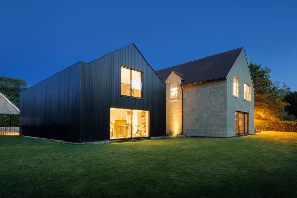 rear view of house at night with lights on