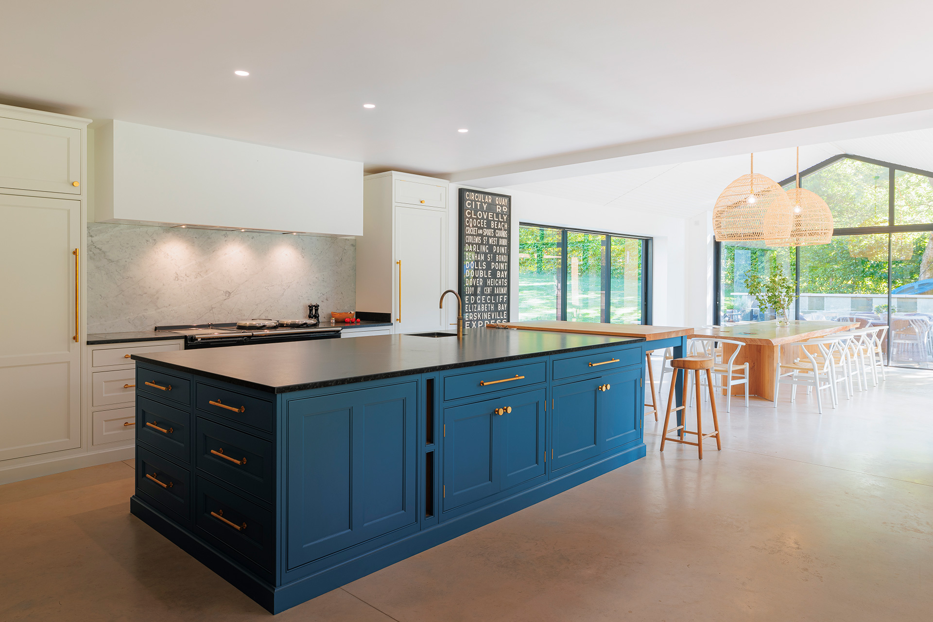 interior large open-plan kitchen diner with blue kitchen island