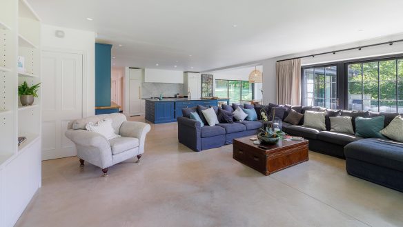 open-plan living kitchen area in white and blue tones