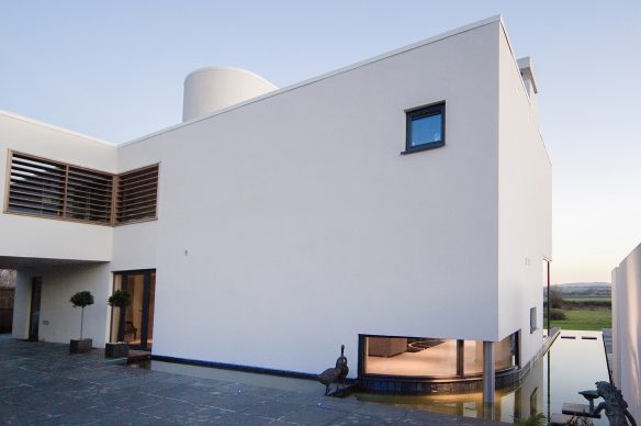 entrance to contemporary house with moat and countryside views