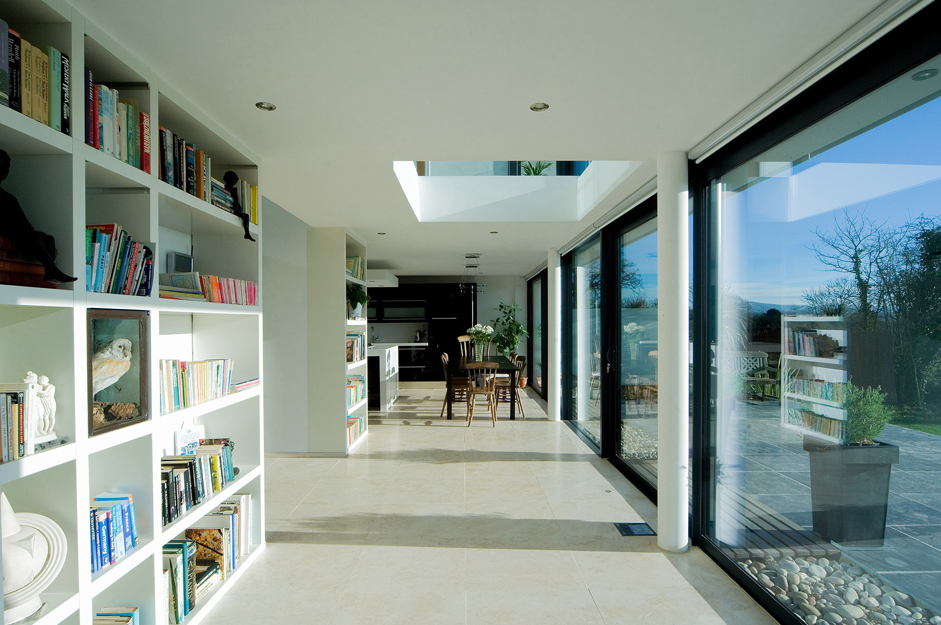 interior open plan hallway leading on to outside patio & garden