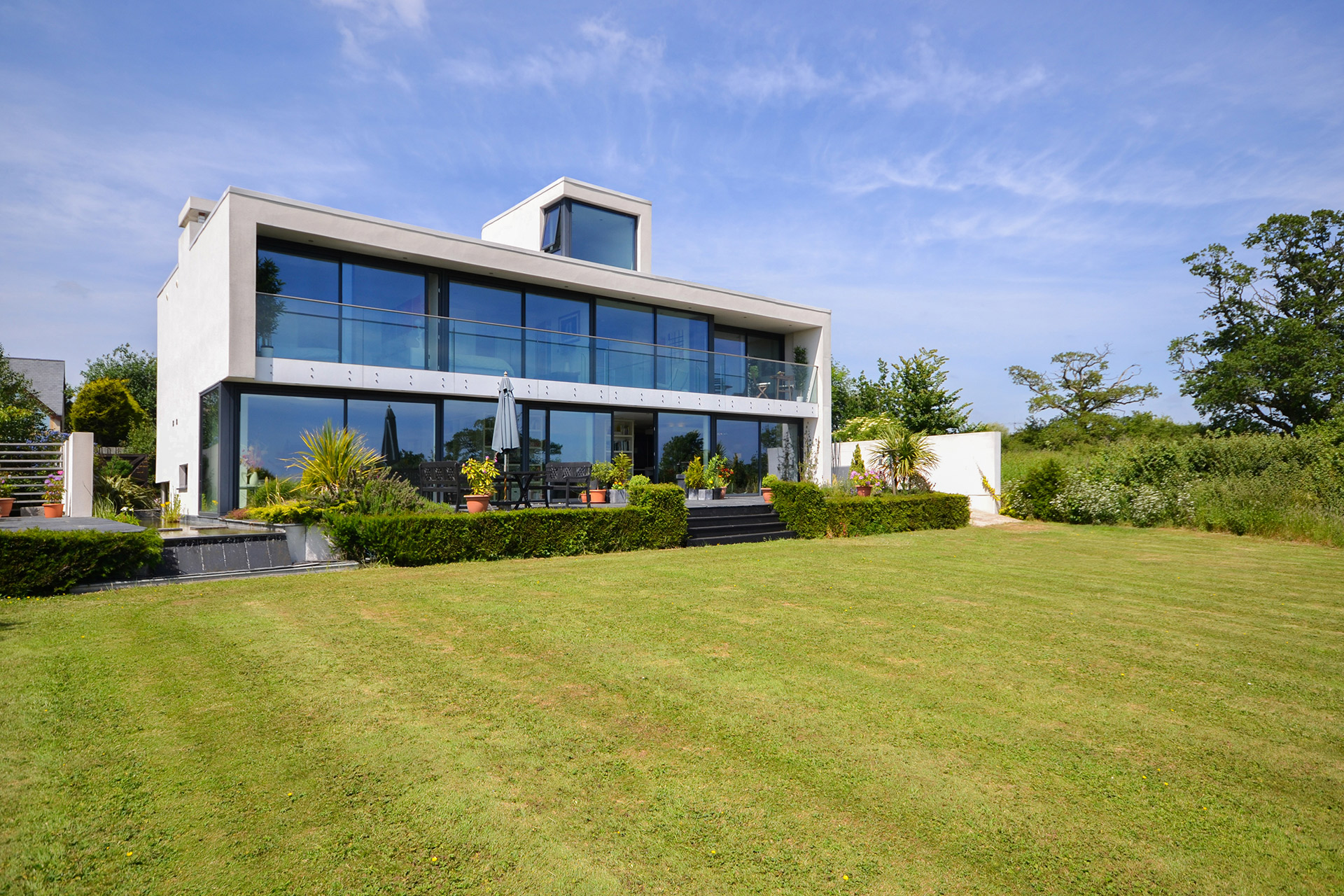 garden view of modern house with large glass frontage