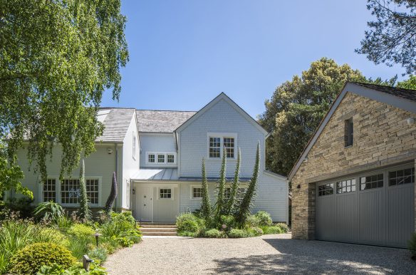 front view of house with new england style and driveway