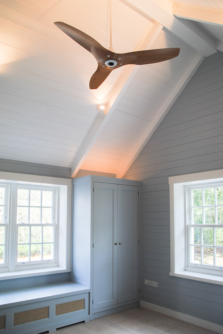 interior bedroom with double aspect windows and a ceiling fan