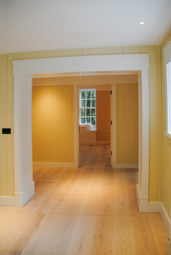 interior hallway with yellow walls and wood floors
