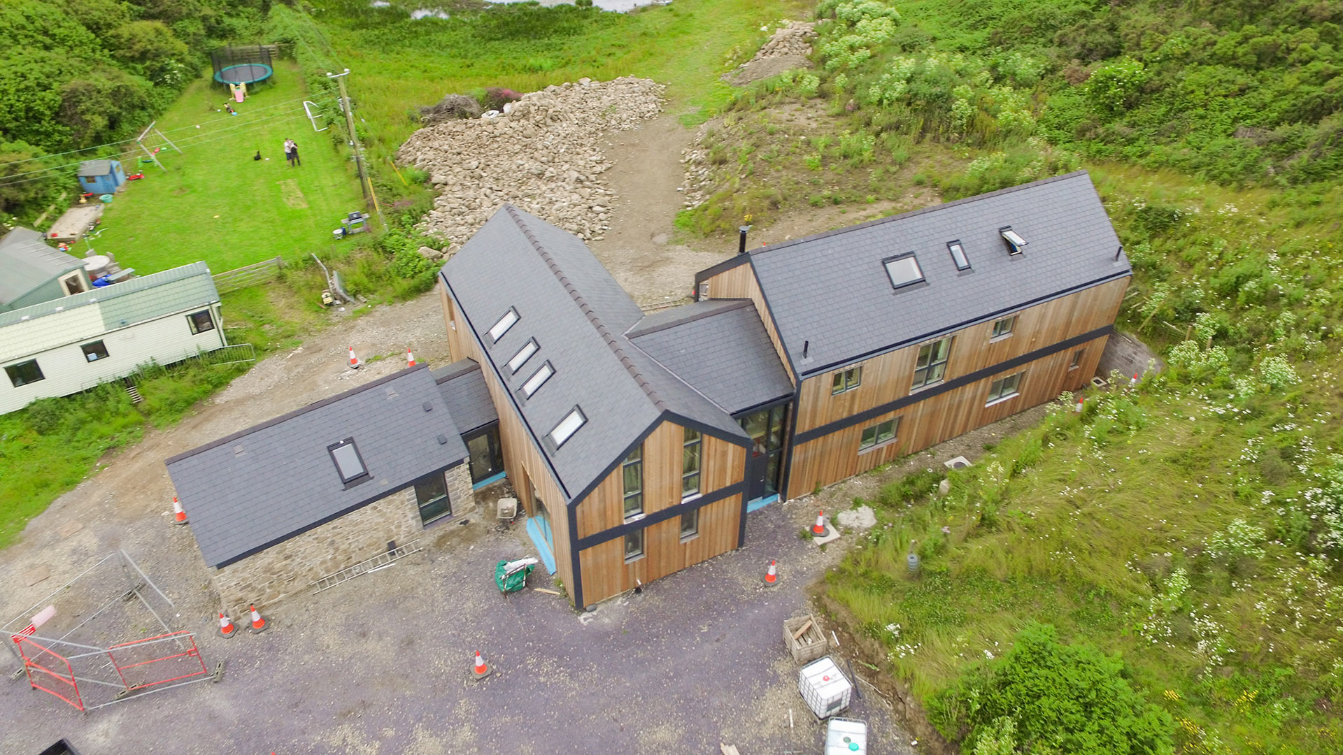 aerial photo of contemporary house with stone and timber cladding under construction