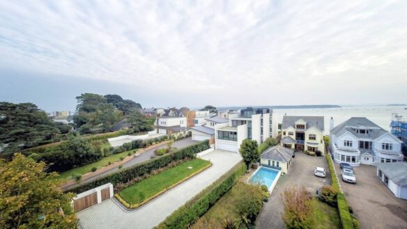 aerial view of contemporary house and driveway which stunning sea views