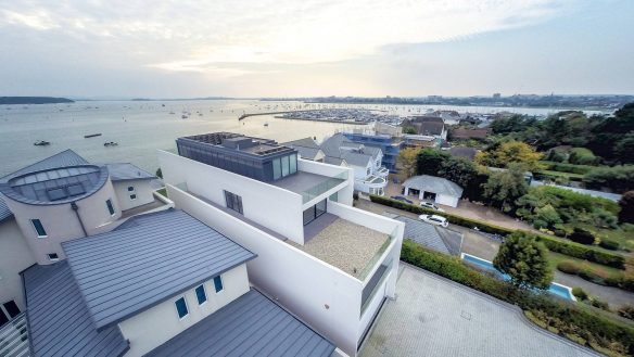 aerial view of house from front with sea views behind