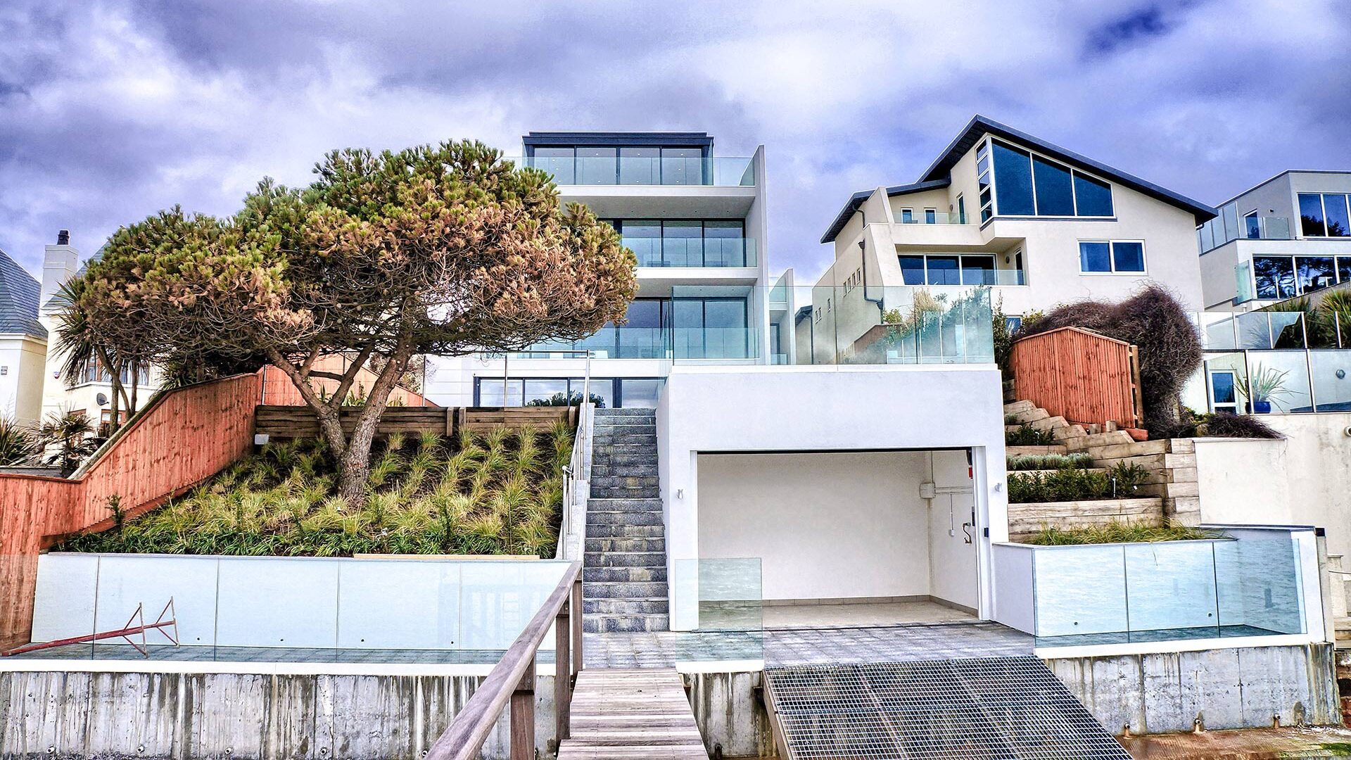 rear view of contemporary house and garden including jetty