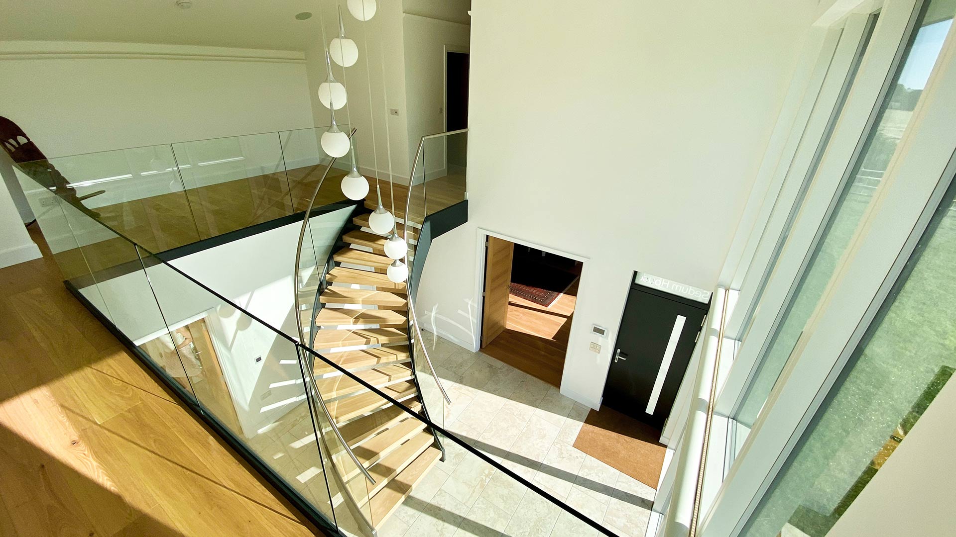 double height entrance hall with hanging light feature