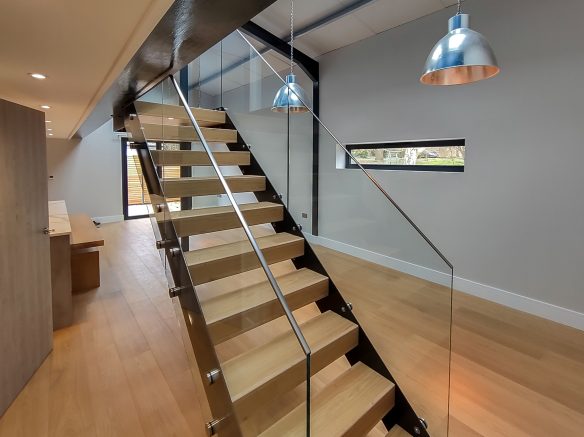 open tread staircase with glass balustrade in living space